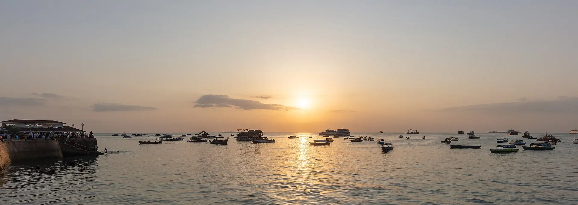 Dhows and small boats on the water at sunset off Stone Town, Zanzibar